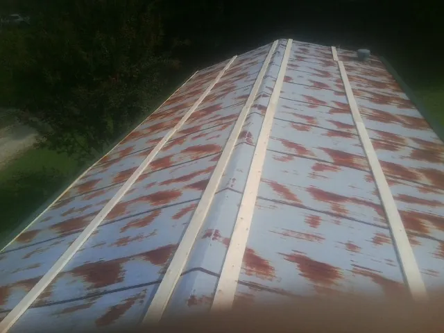 Rusted metal roof panels with new wood purlins before replacement — Storm Damage Roof Repair in Running Springs by Roofing Brothers