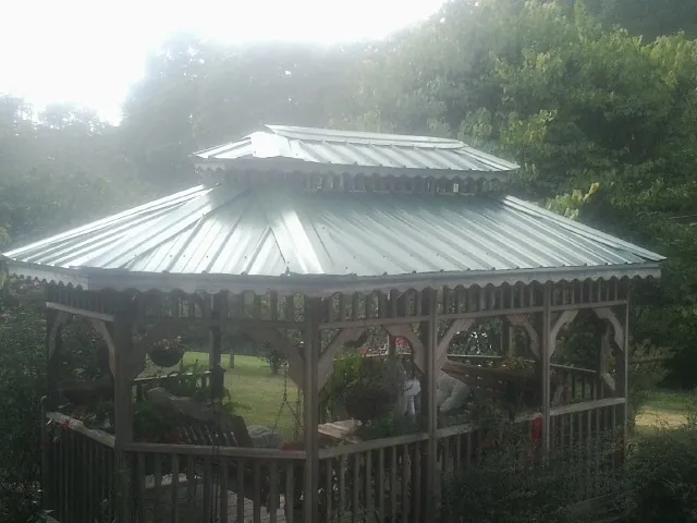 Two tier green metal roof on a garden gazebo in Running Springs