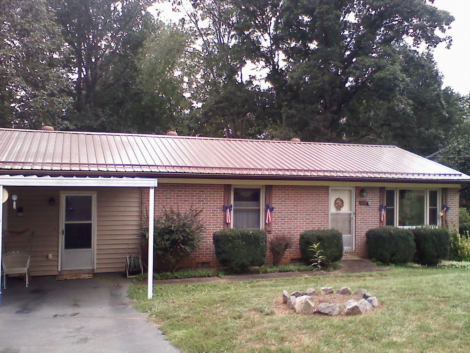 Bronze metal roof and carport on a brick ranch home — Roof Repair work by our crew in Running Springs